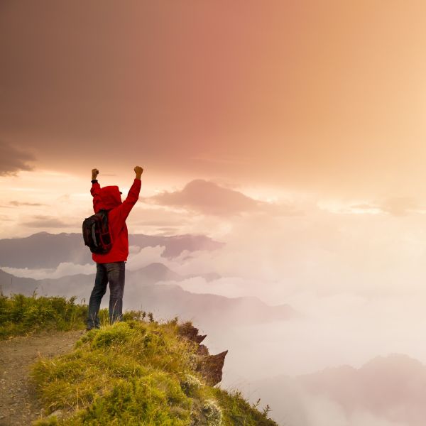 man with arms raised in celebration after recovery